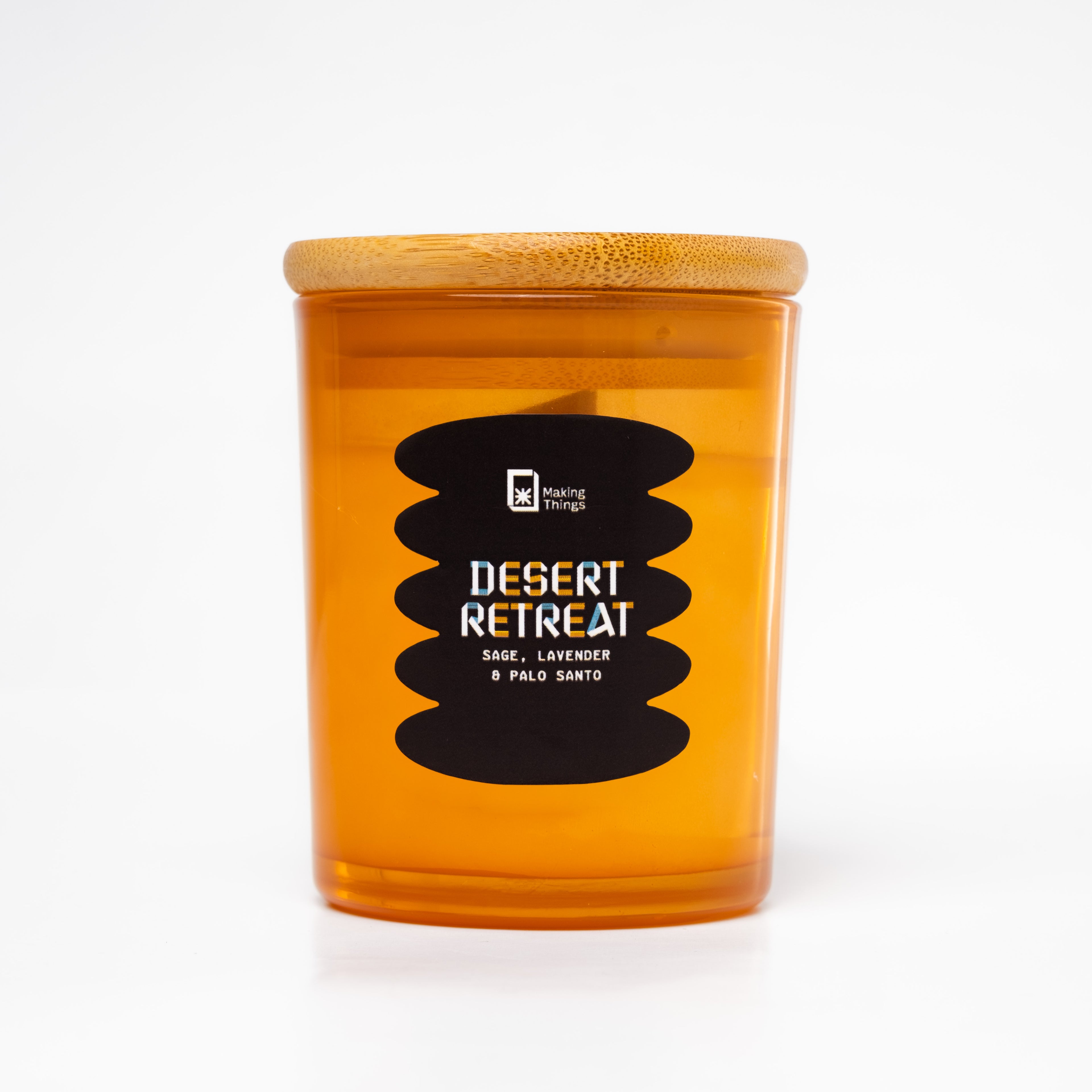 A scented candle with notes of sage, lavender, and palo santo. It is packaged in a orange jar with a wooden lid.
