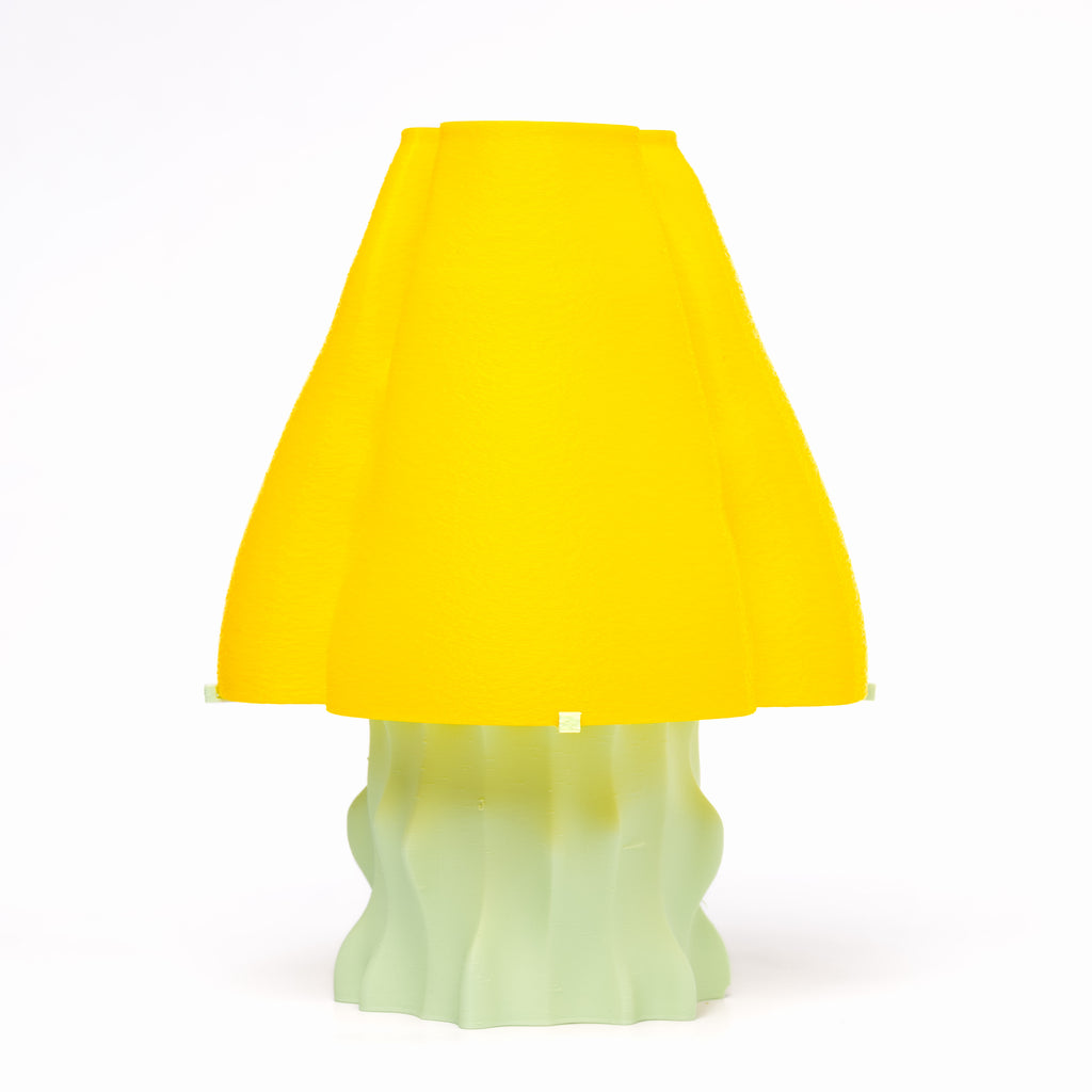 A yellow, mushroom-shaped, 3D-printed lamp with a mint green base.
