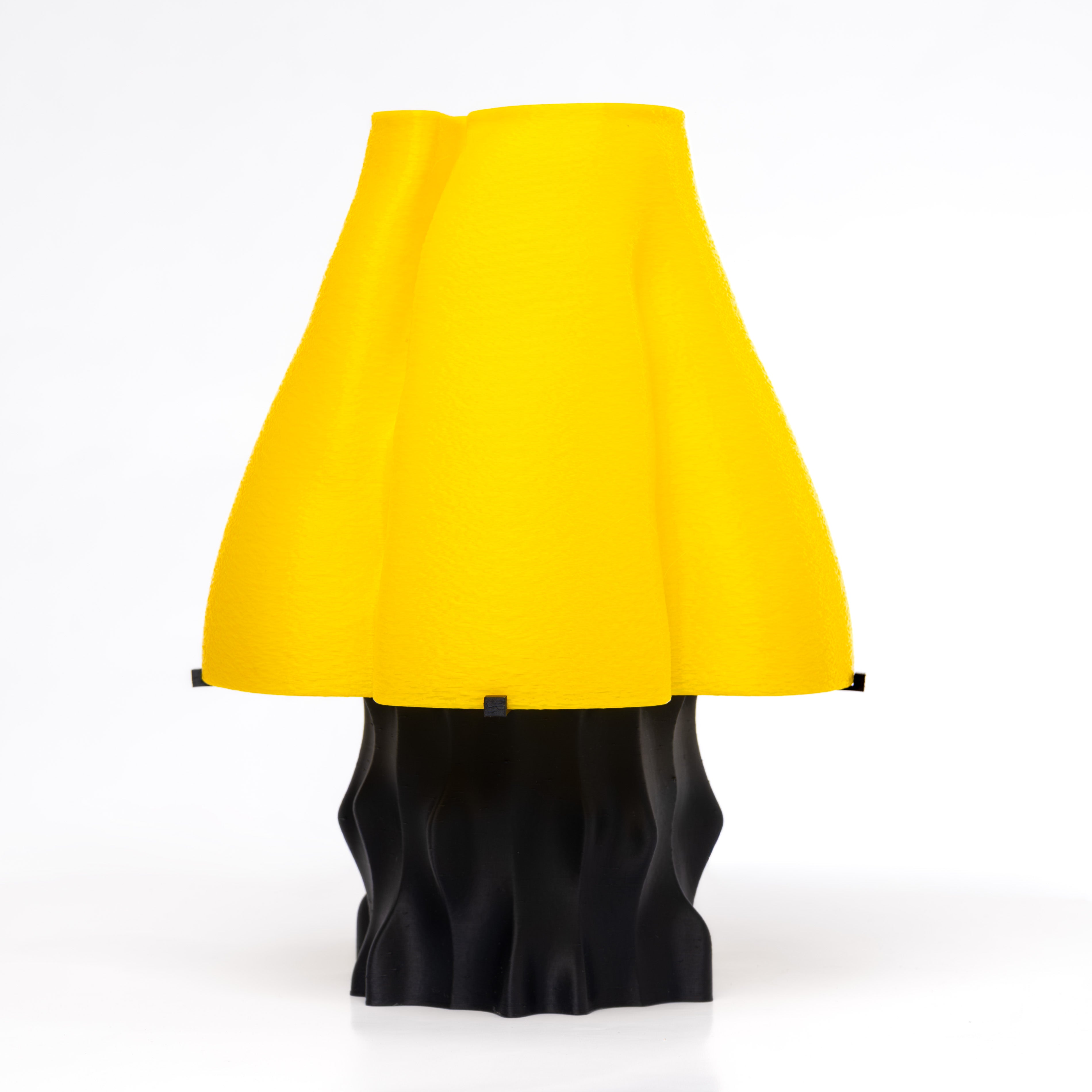 A yellow, mushroom-shaped, 3D-printed lamp with a black base.