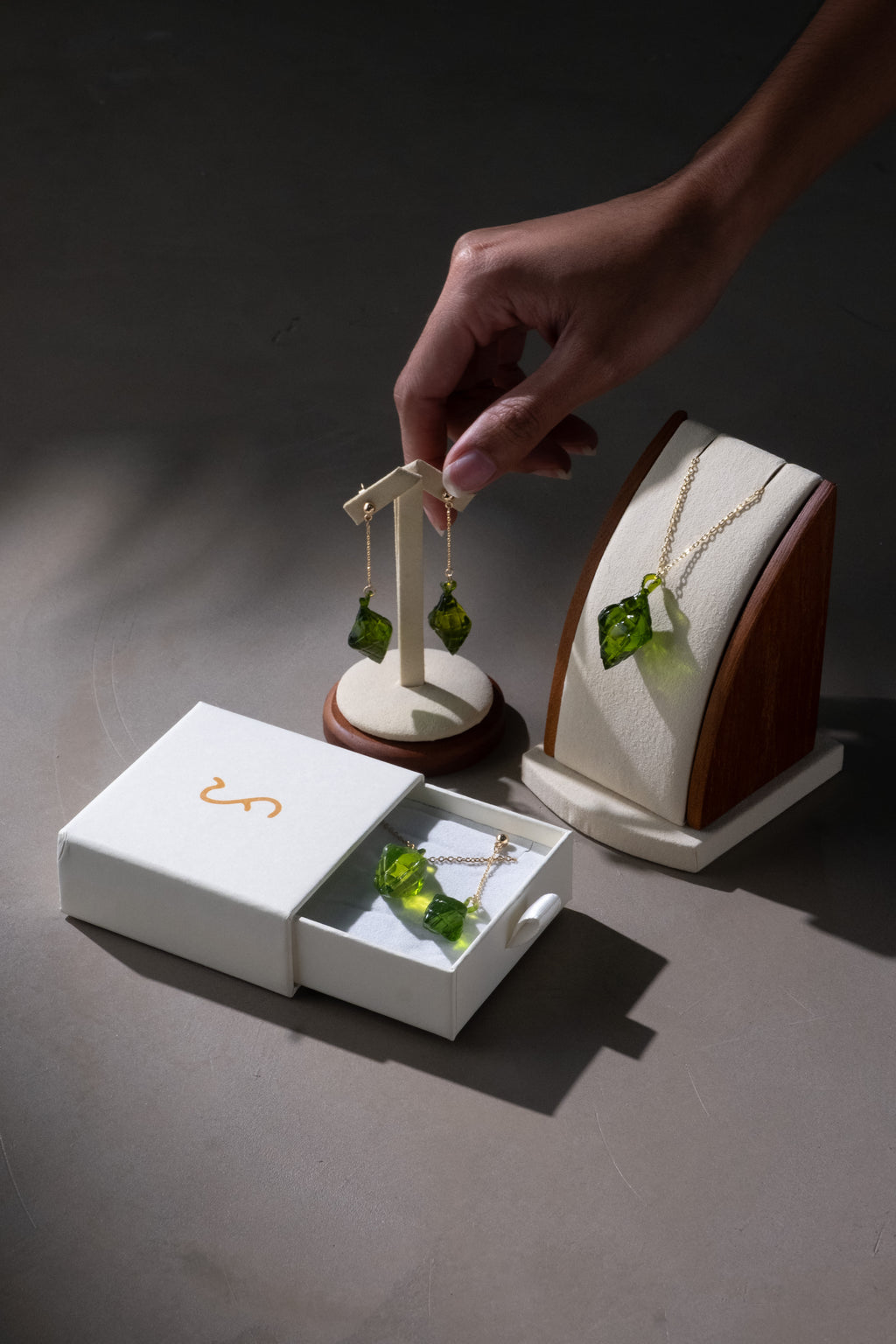 The Making Things Pusô Jewelry Collection displayed on a stand and in a box.