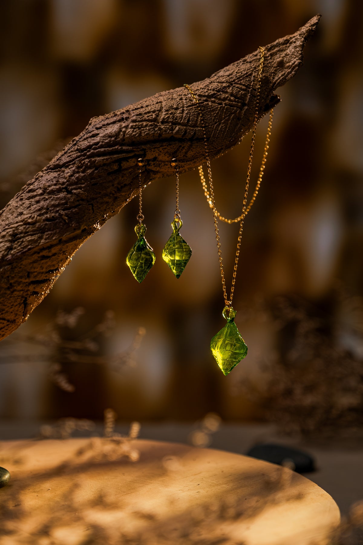 The Making Things Pusô Jewelry Collection on displayed on a wooden branch. 