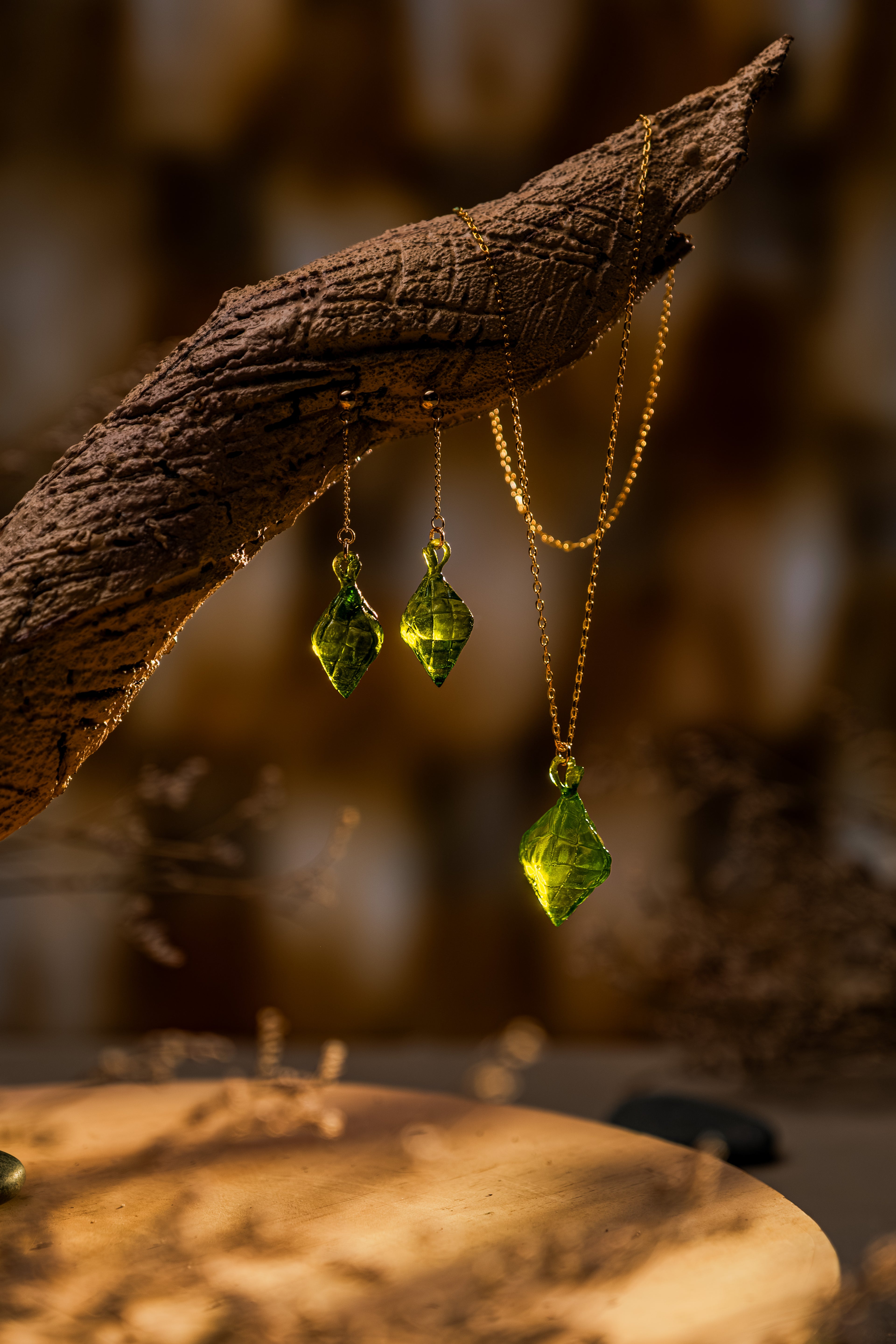 The Making Things Pusô Jewelry Collection on displayed on a wooden branch. 