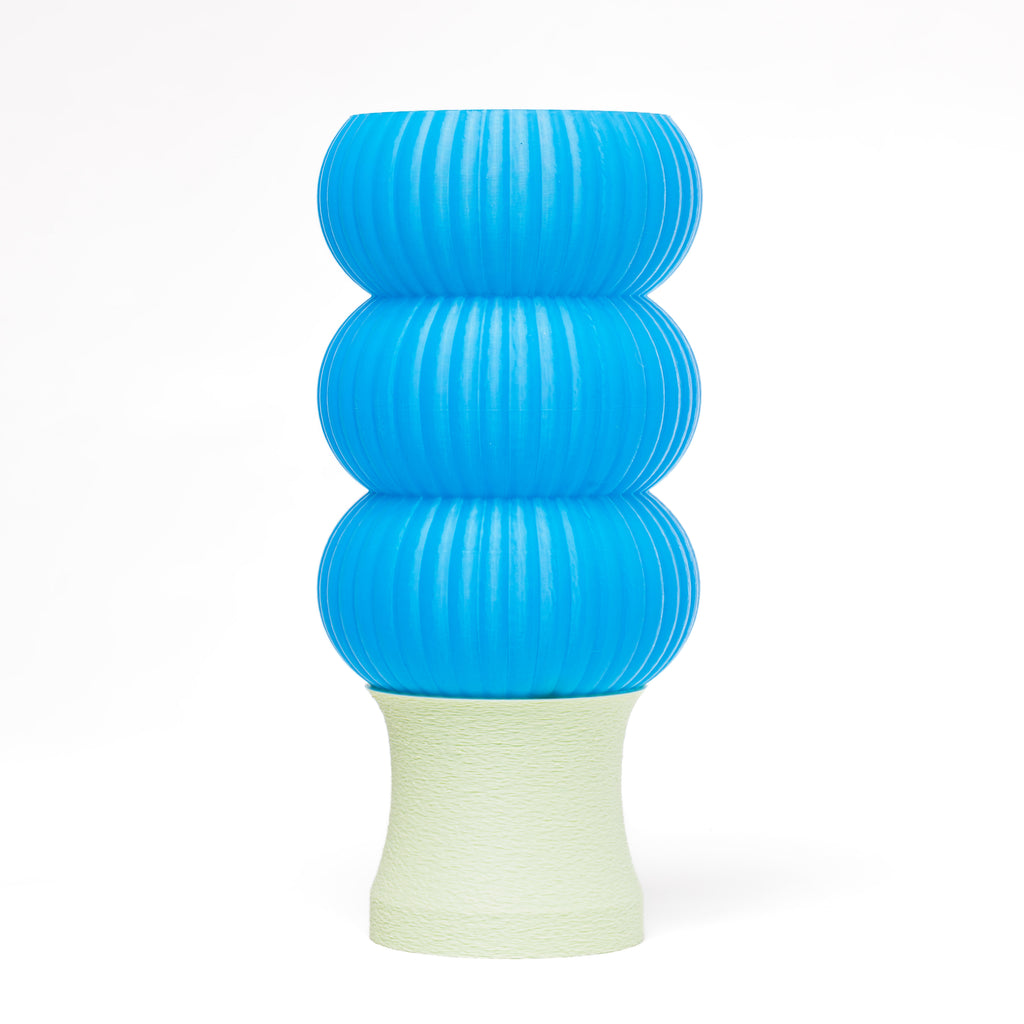 A blue 3D-printed lamp with a mint green base.