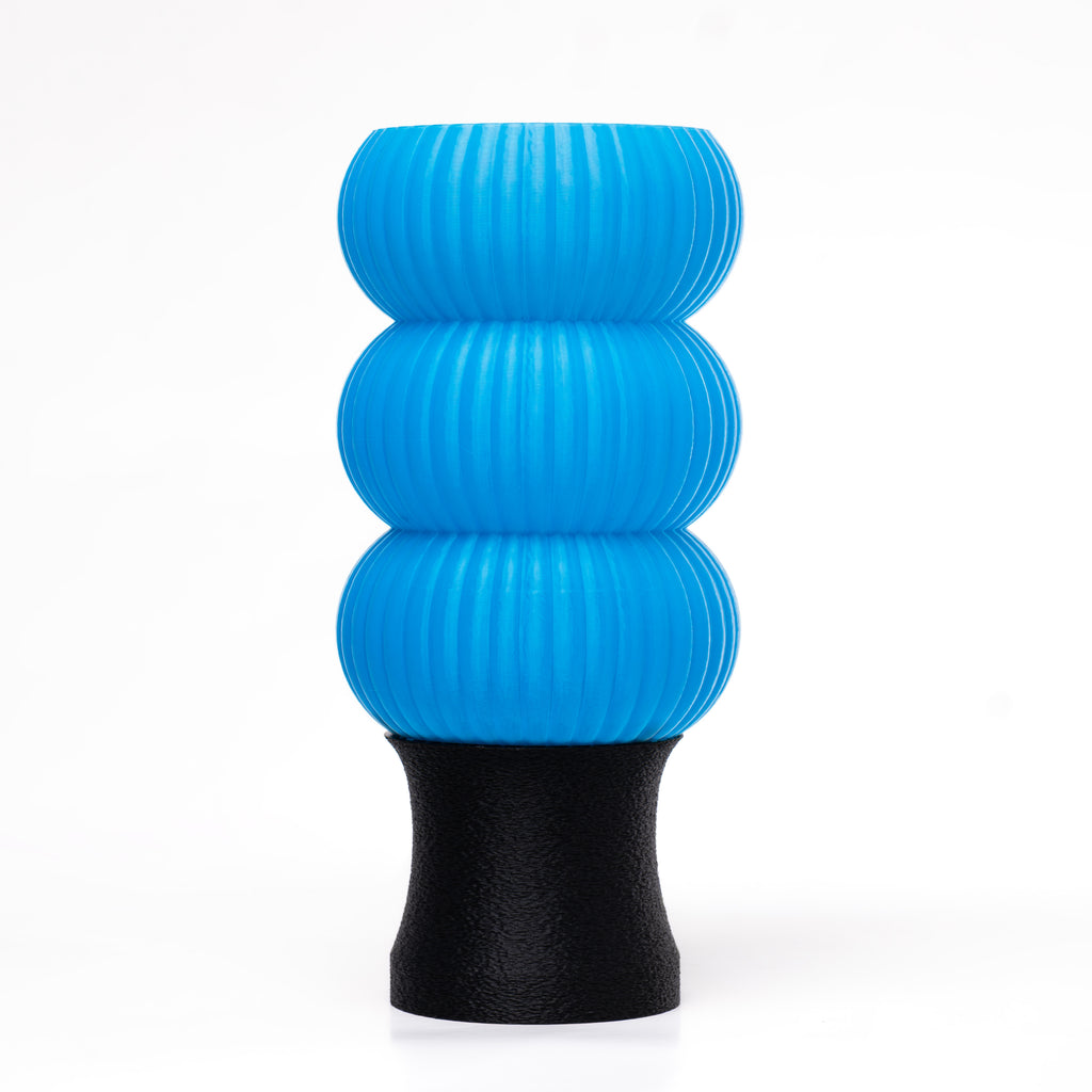 A blue 3D-printed lamp with a black base.