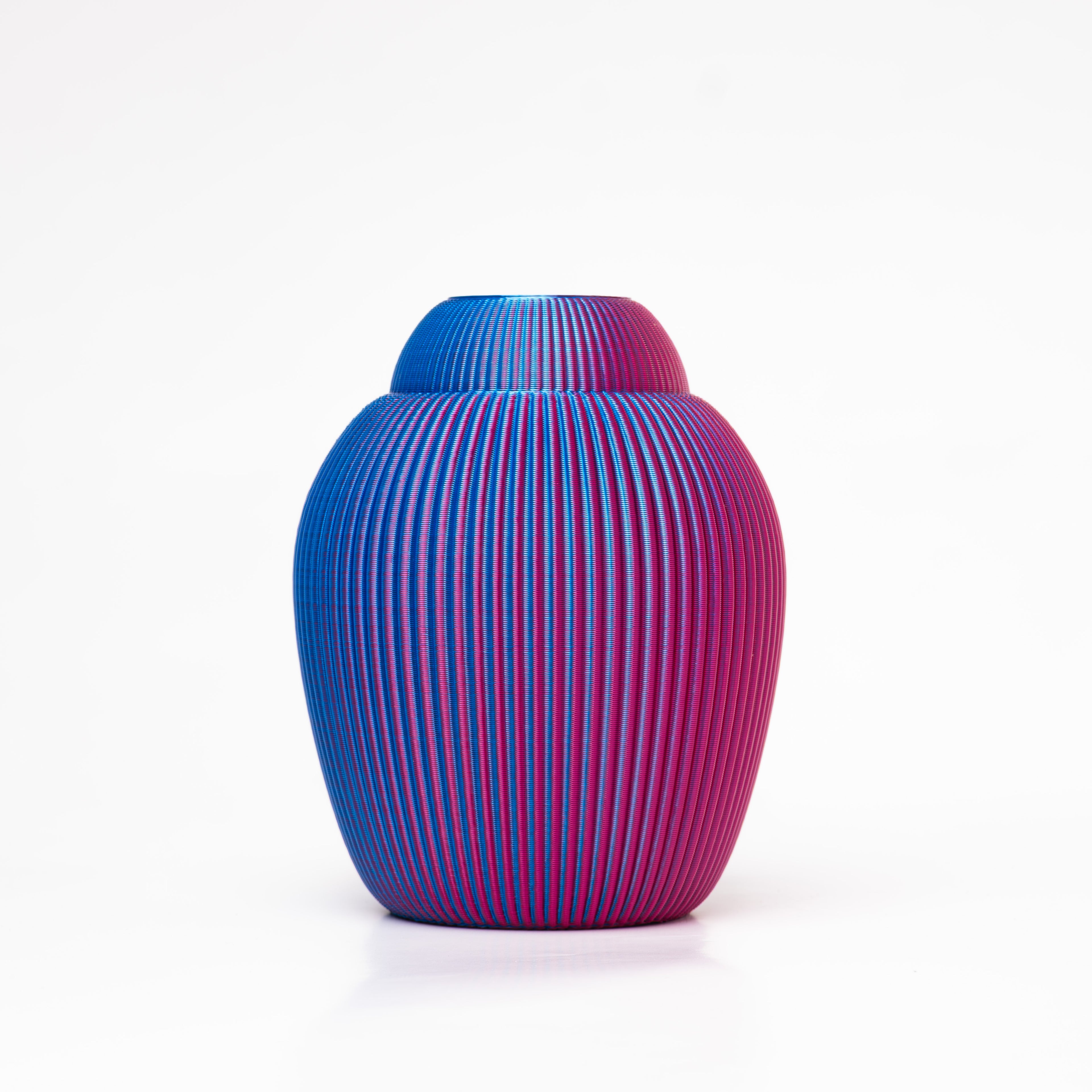 A 3D-printed iridescent vase that changes from blue to purple and vice versa.
